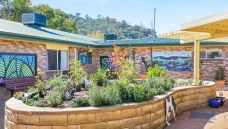 Bupa-Aged-Care-Tamworth-outside-area-with-raised-garden-beds-and-murals