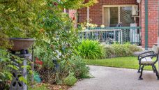 Bupa-Aged-Care-Enfield-garden-with-chair